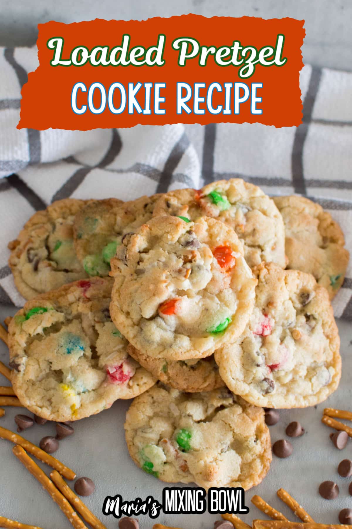 loaded pretzel cookies on a marble counter with pretzels and chocolate chips around it