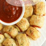 puff pastry pizza bites on a white plate with a bowl of marinara sauce