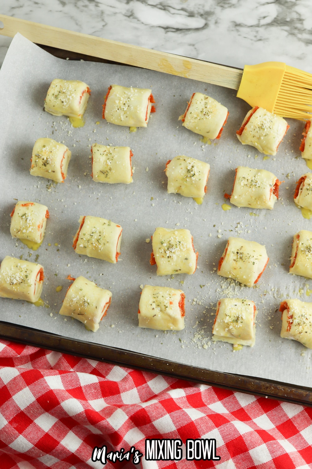 unbaked pizza bites on a parchment lined baking sheet