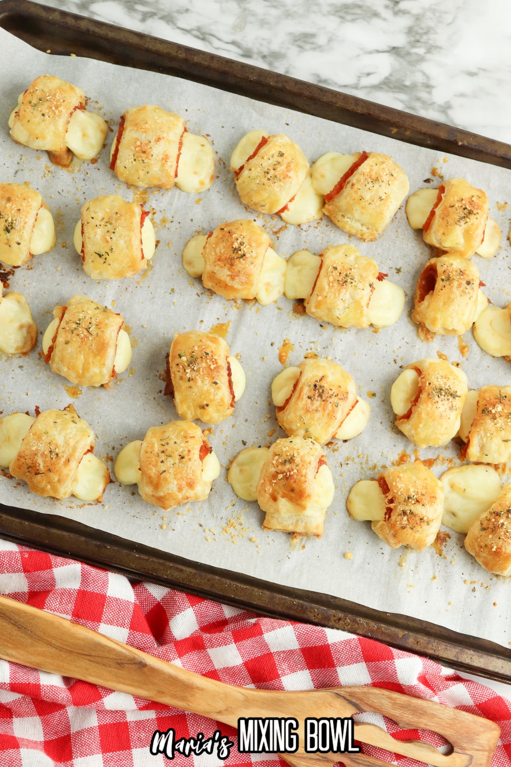 baked pizza bites on parchment lined baking sheets