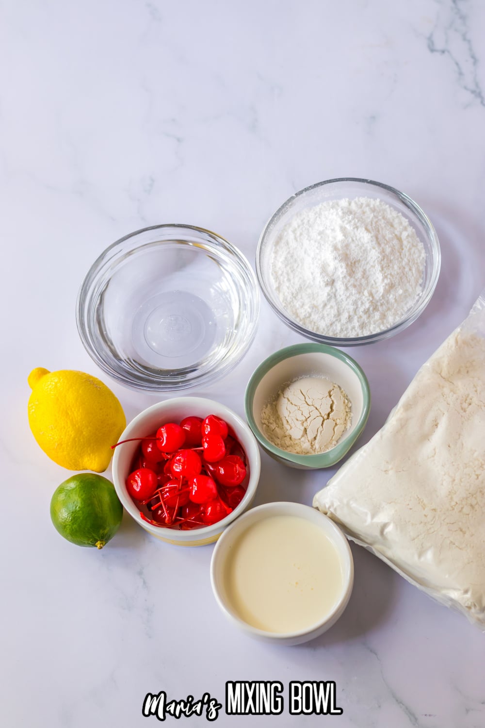 bowls of lemon lime soda, cherries, powdered sugar, heavy cream, a lemon, lime, and white cake mix on a white background