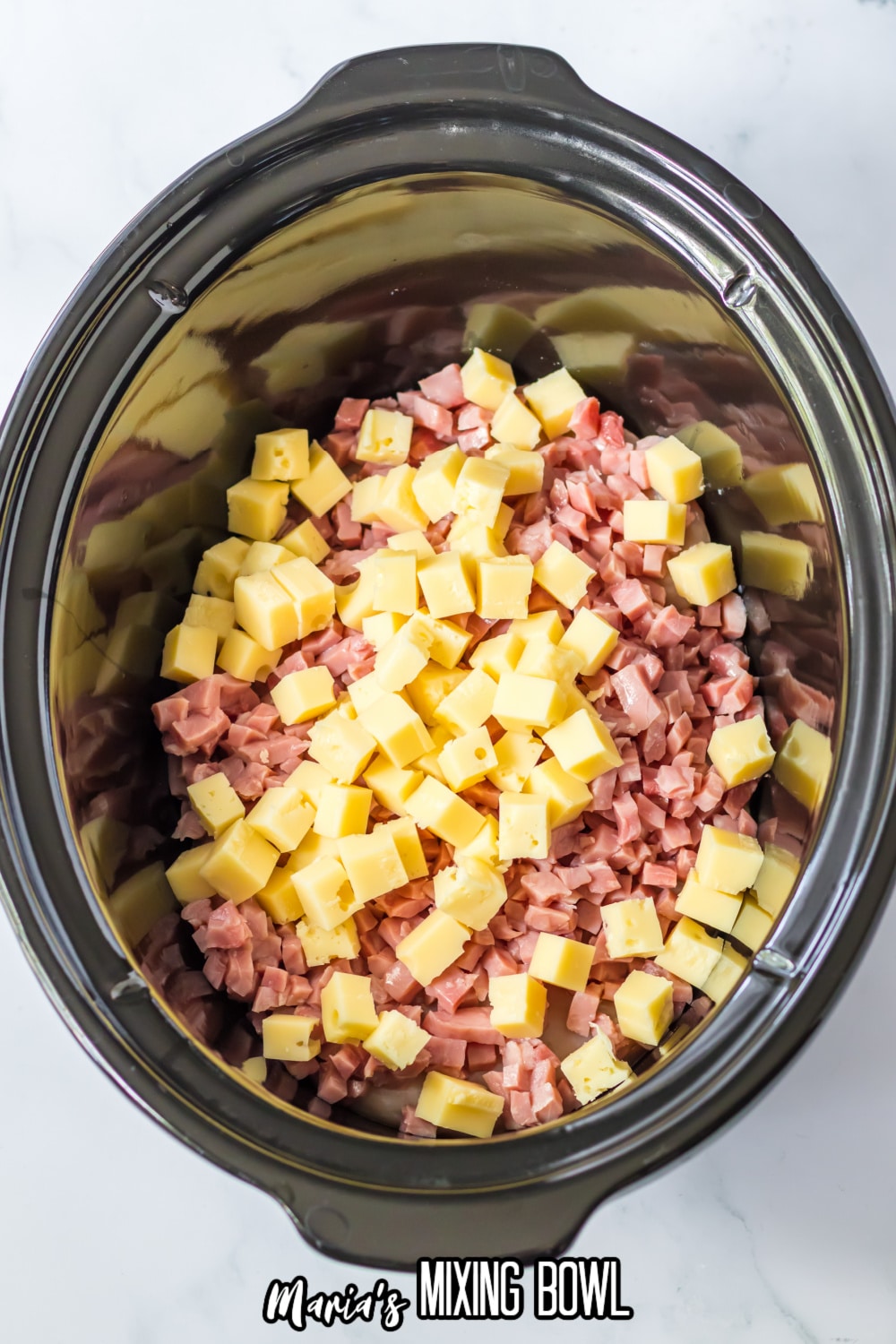 chicken breasts, diced ham and diced cheese in a slow cooker
