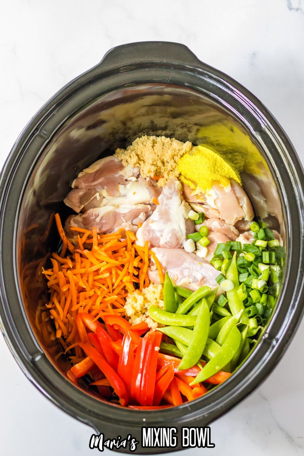 ingredients added into the slow cooker liner