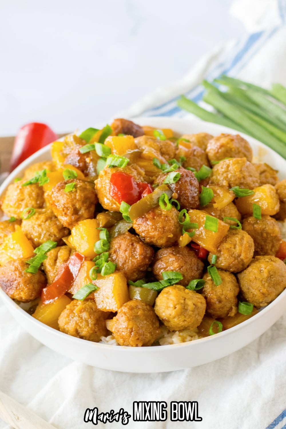 white bowl filled with hawaiian meatballs on top of a bed of rice