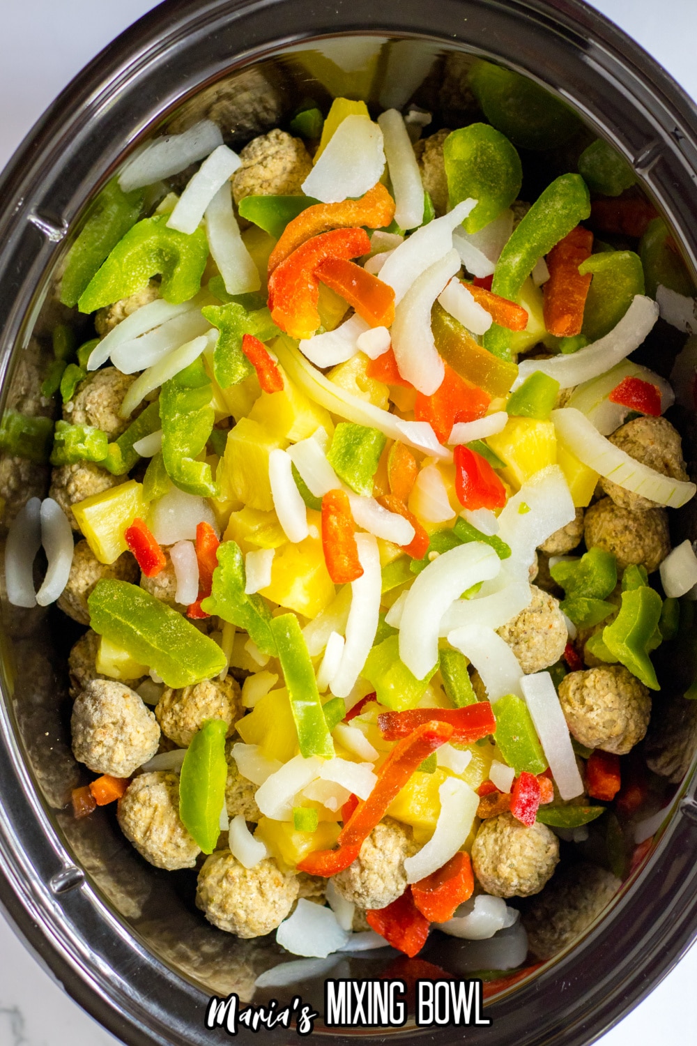 peppers, pineapple, and frozen meatballs in a slow cooker