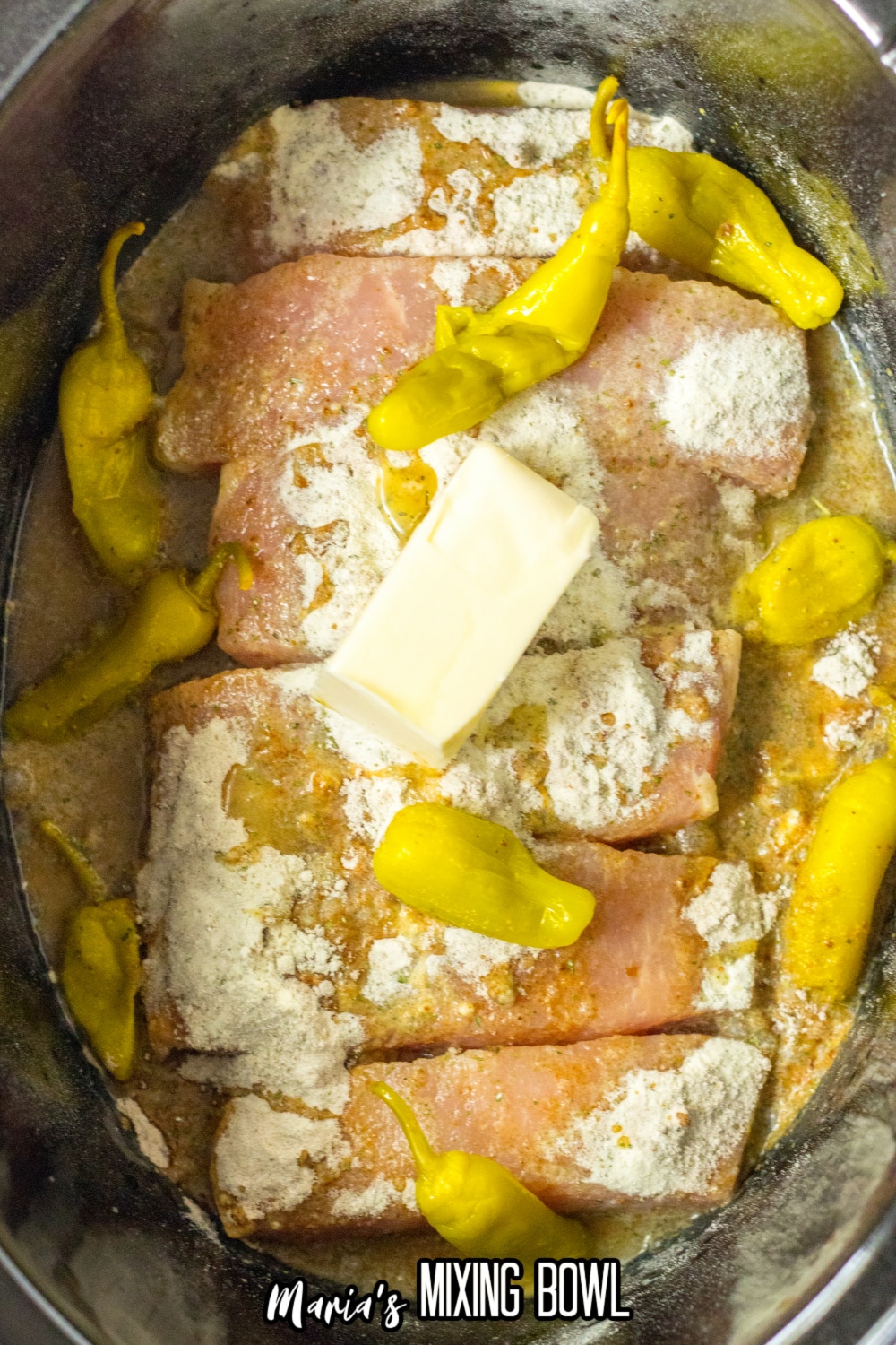 raw pork ribs, peppers, butter, and au jus in a slow cooker