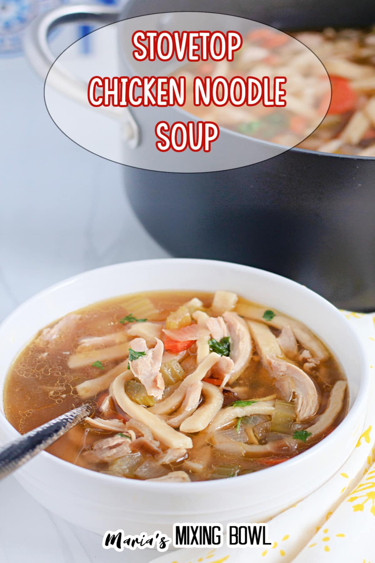 white bowl filled with chicken noodle soup with a large pot of soup in the background