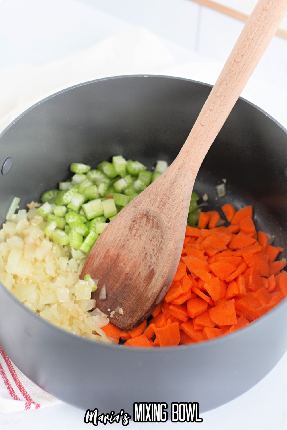 sautéed onions, celery and carrots in a large dark colored pot