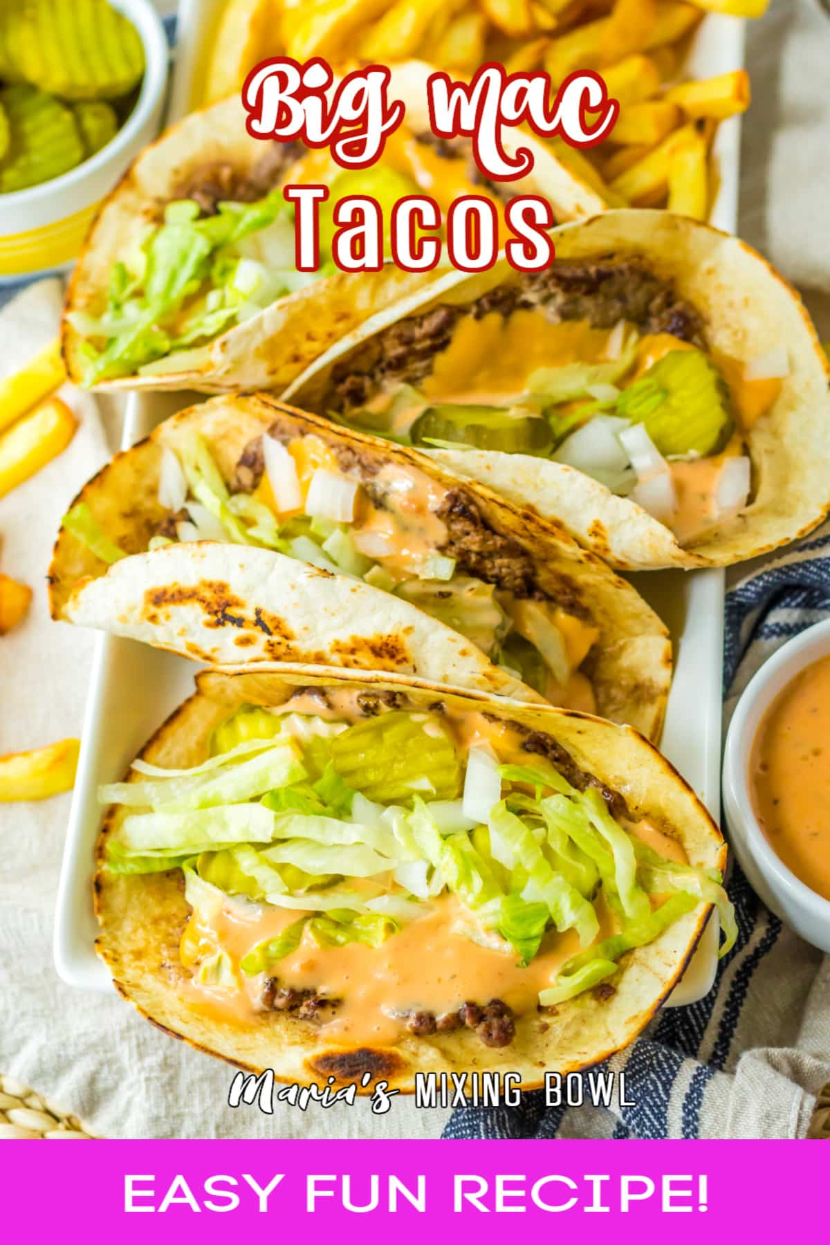 four big mac tacos and a side of fries on a white platter.