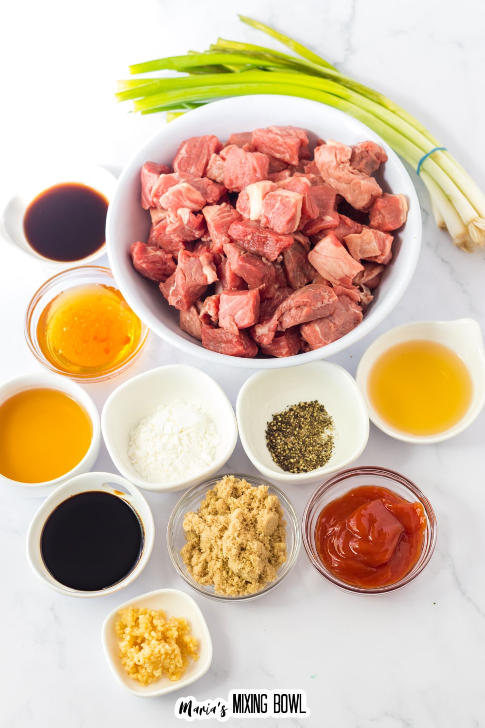 bowls of raw steak, bourbon, honey, brown sugar, ketchup, soy sauce, worcestershire sauce, minced garlic, black pepper, apple cider vinegar, cornstarch, water, and parsley.