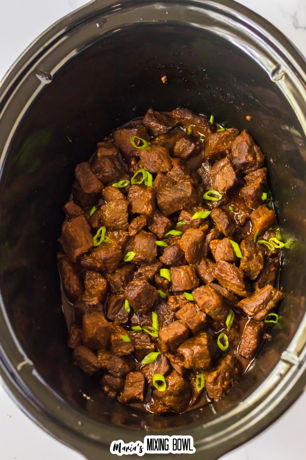 cooked bourbon steak bites in the slow cooker.