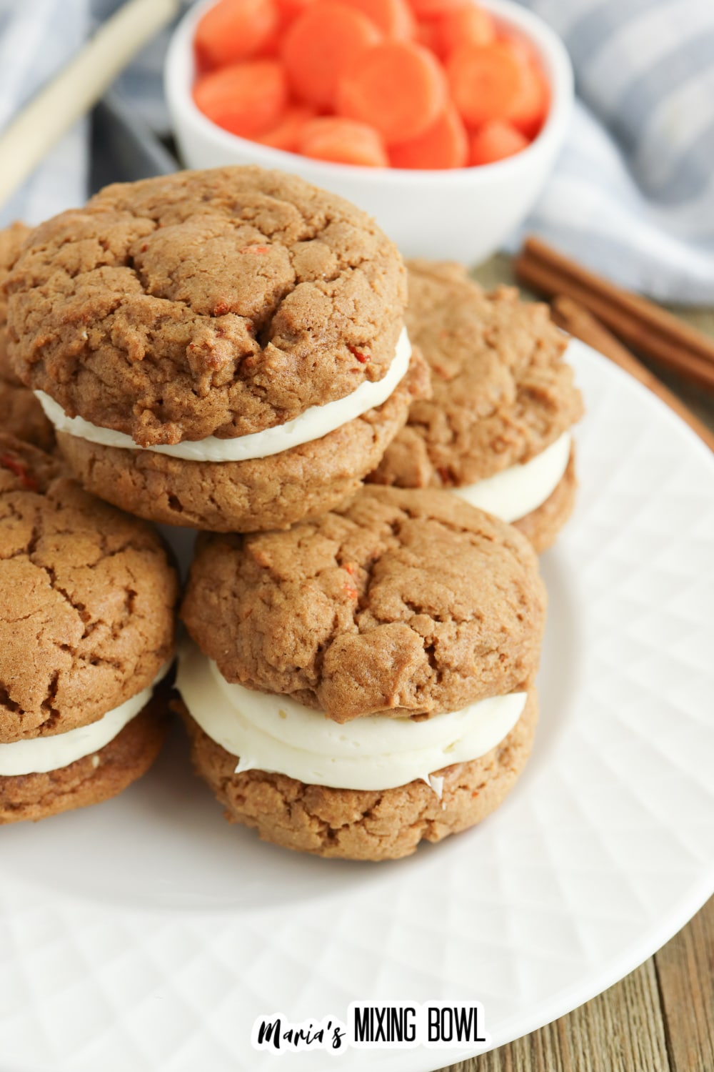 five carrot cake mix cookies stacked on a white plate.