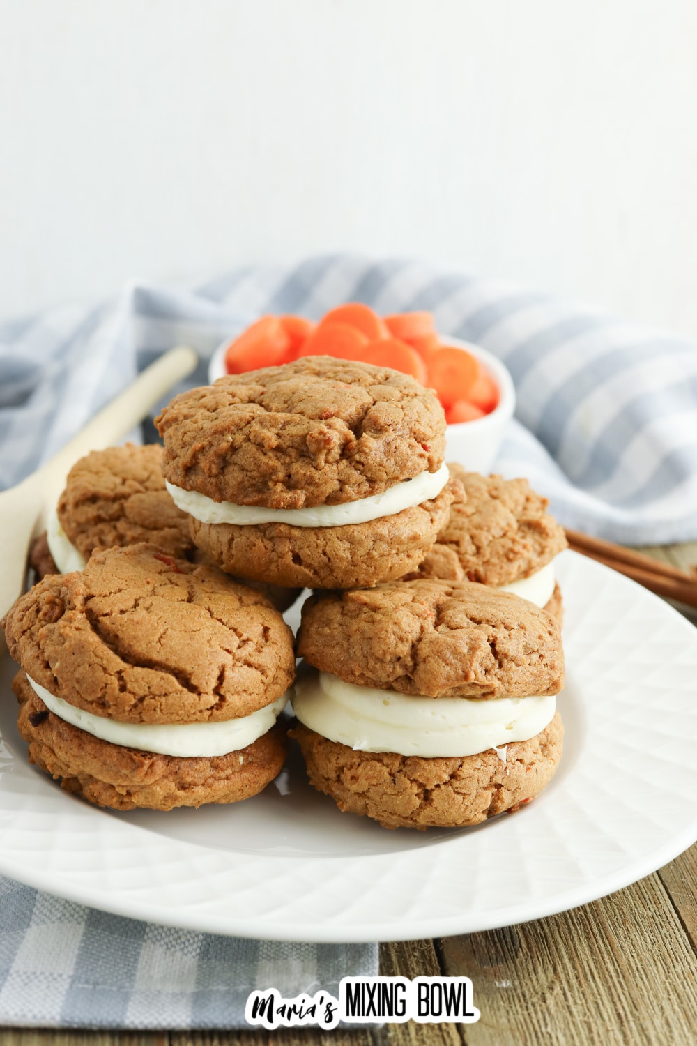 five carrot cake mix cookies stacked on a white plate.
