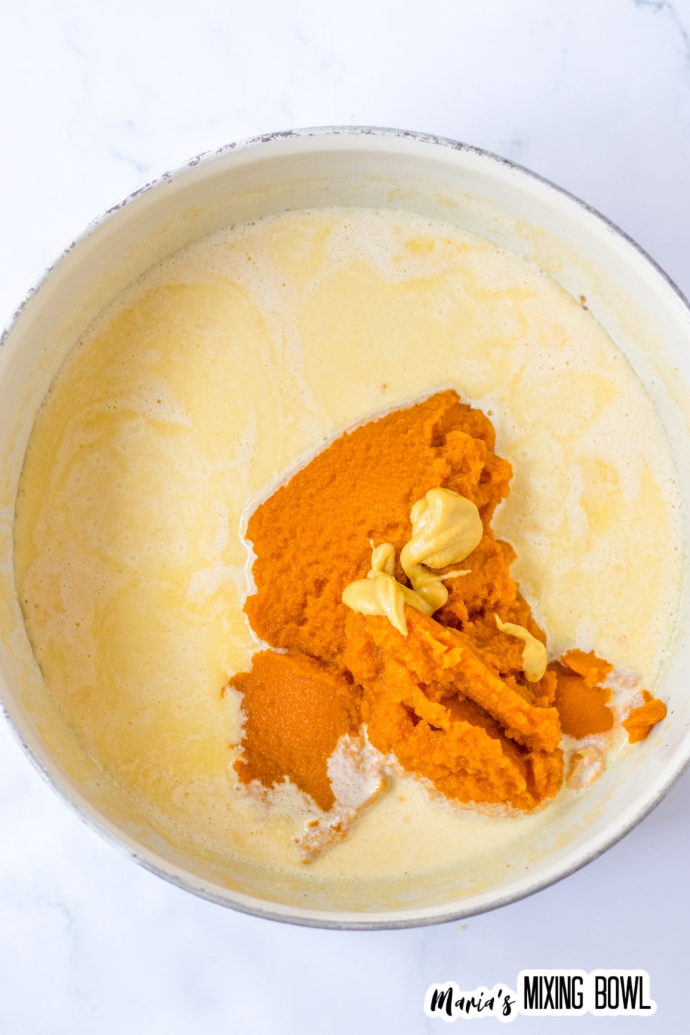 pumpkin cheese sauce being cooked in a large pot.