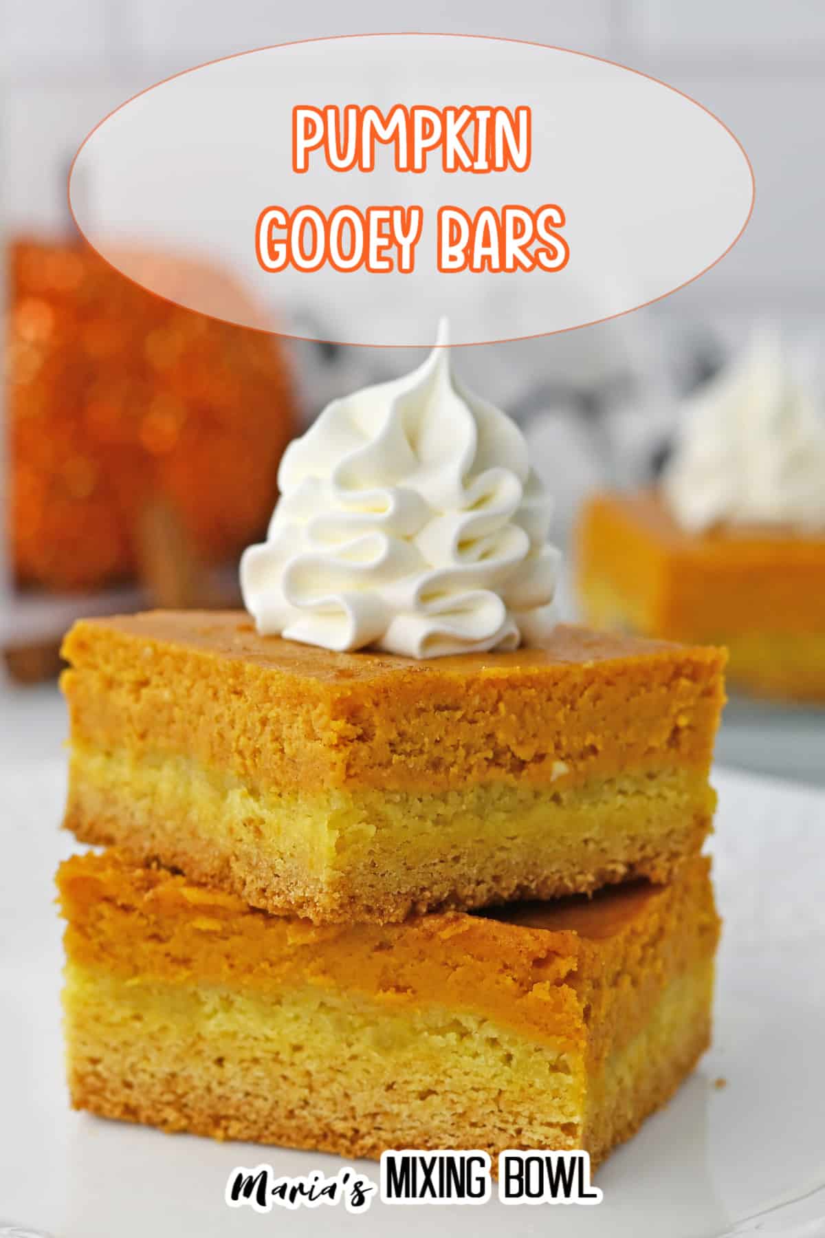 two gooey pumpkin bars stack on a plate.