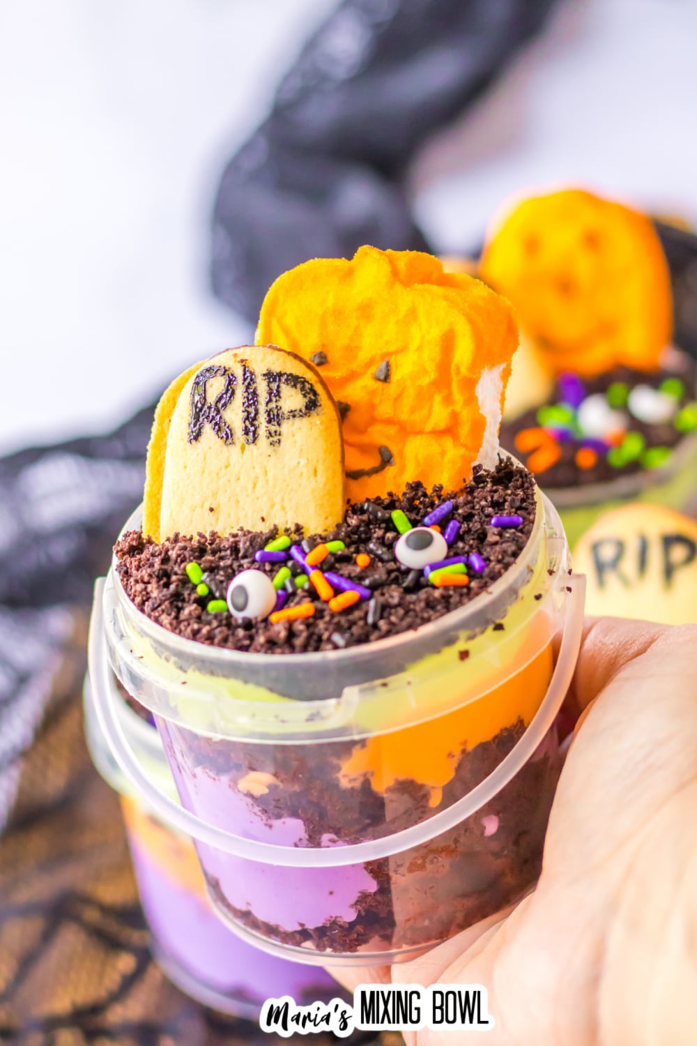 graveyard dirt cups held in a woman's hand.