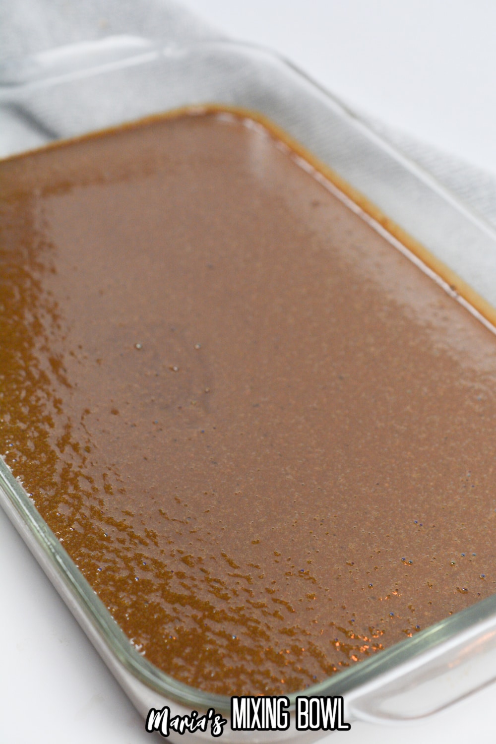 raw chocolate cake batter in a 9x13 glass baking dish.