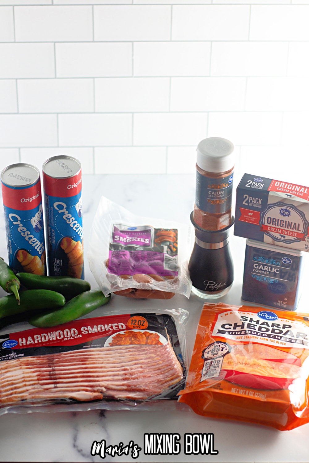 cans of crescent rolls, jalapeno peppers, lil smokes, bacon, cheddar cheese, cream cheese, garlic, cajun seasoning, and pepper.