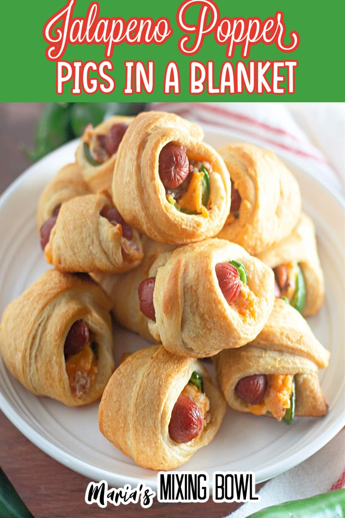 jalapeno crescents pigs in a blanket stacked on top of each other on a plate.