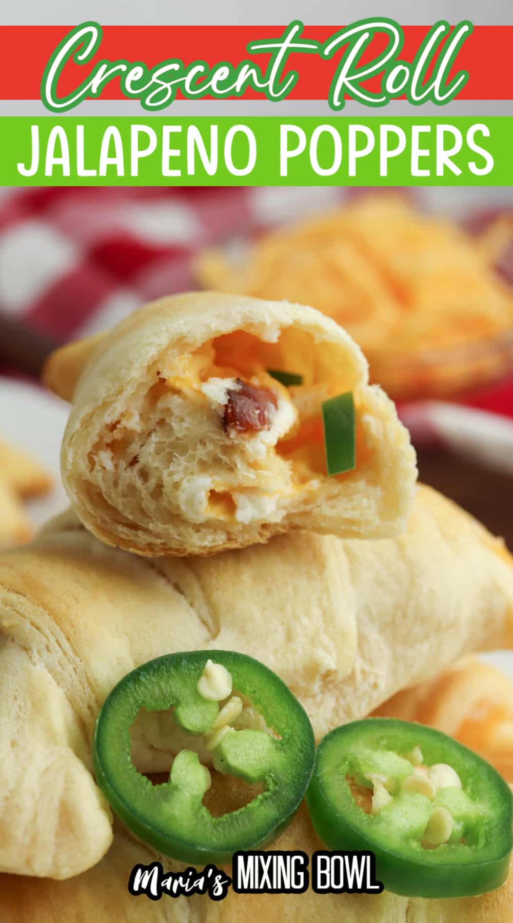 half of a jalapeno popper crescent roll cut open stacked on top of a whole one.