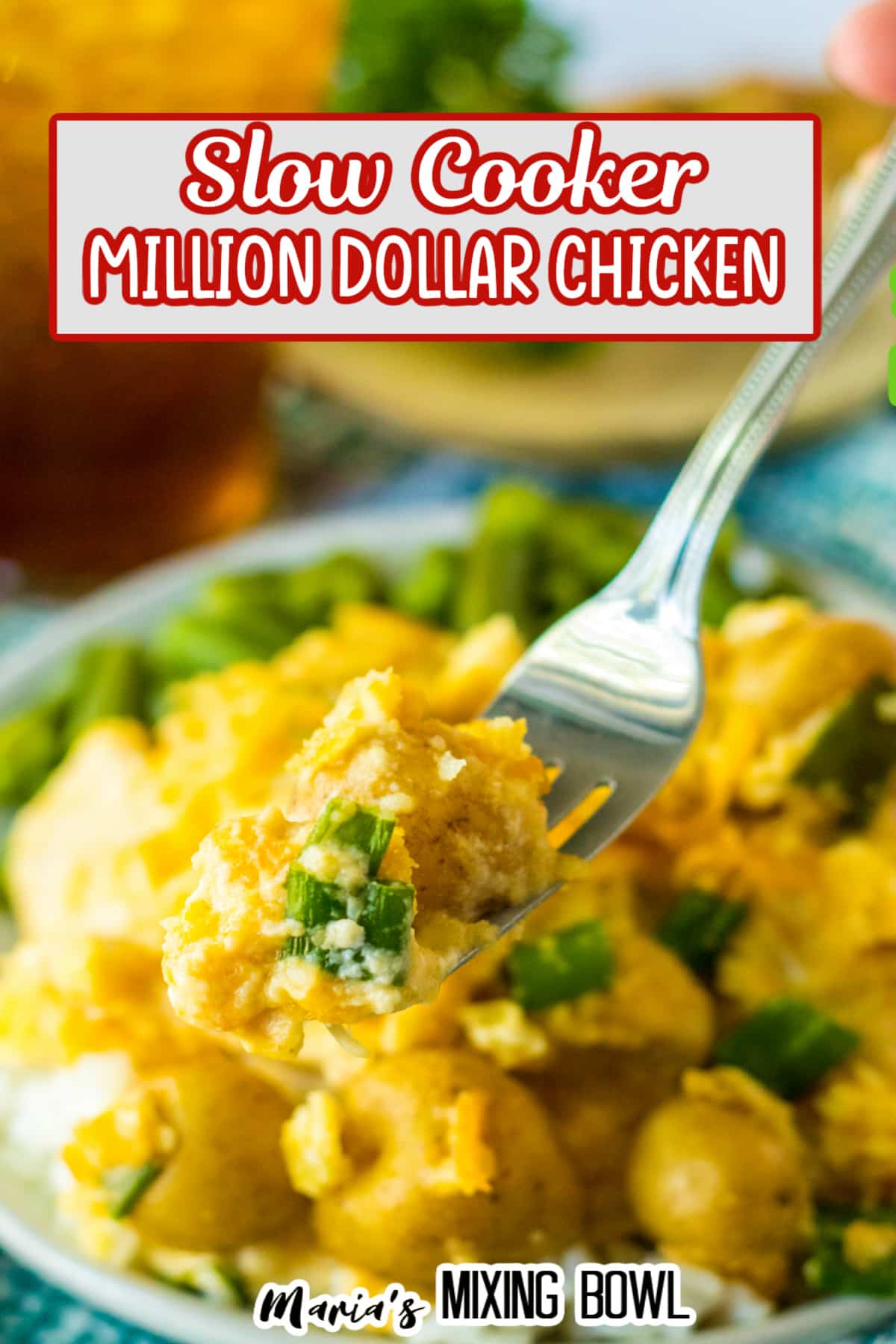 bite of million dollar chicken on a fork held in the air.