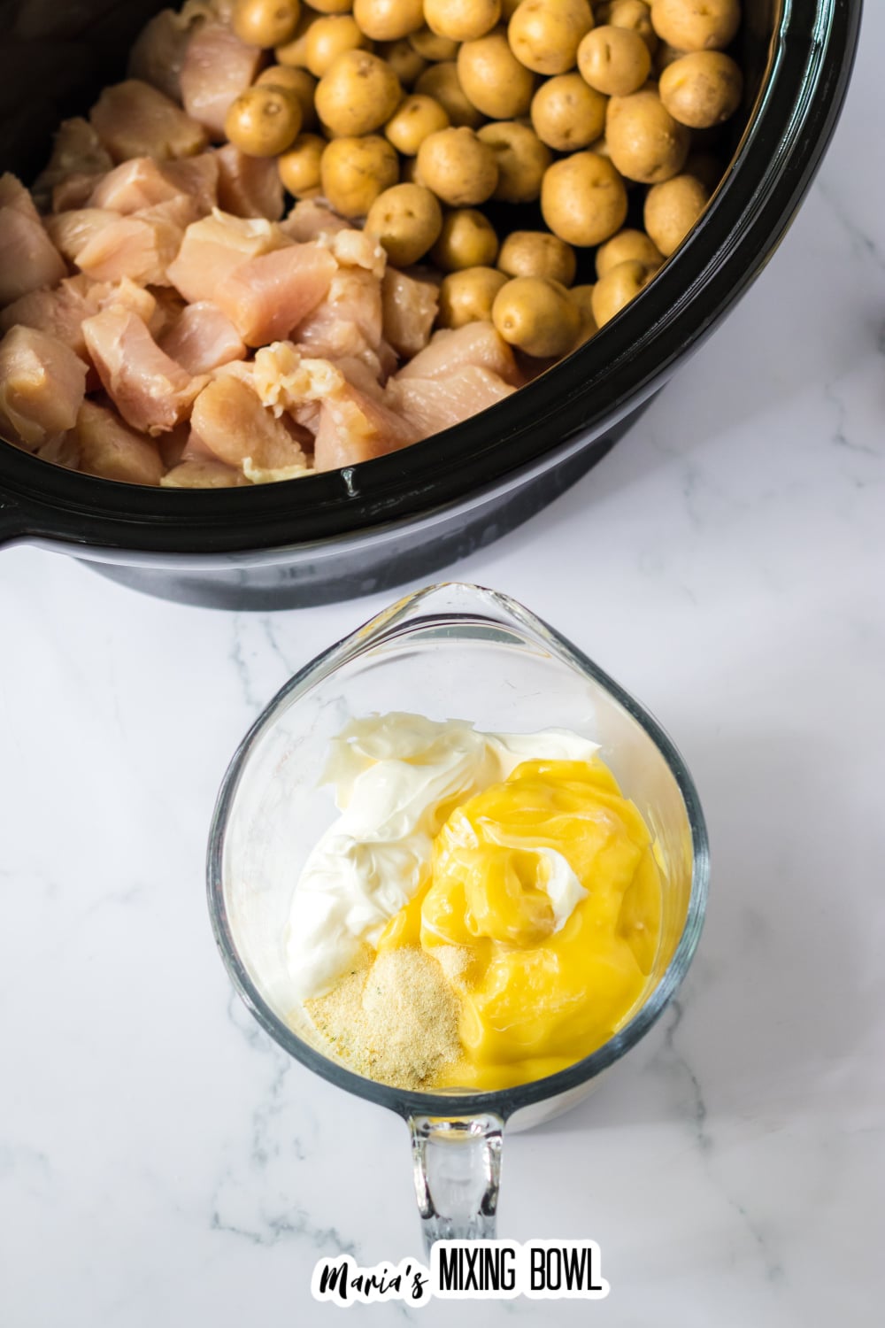 cream of chicken soup, and sour cream being mixed in a glass measuring cup.