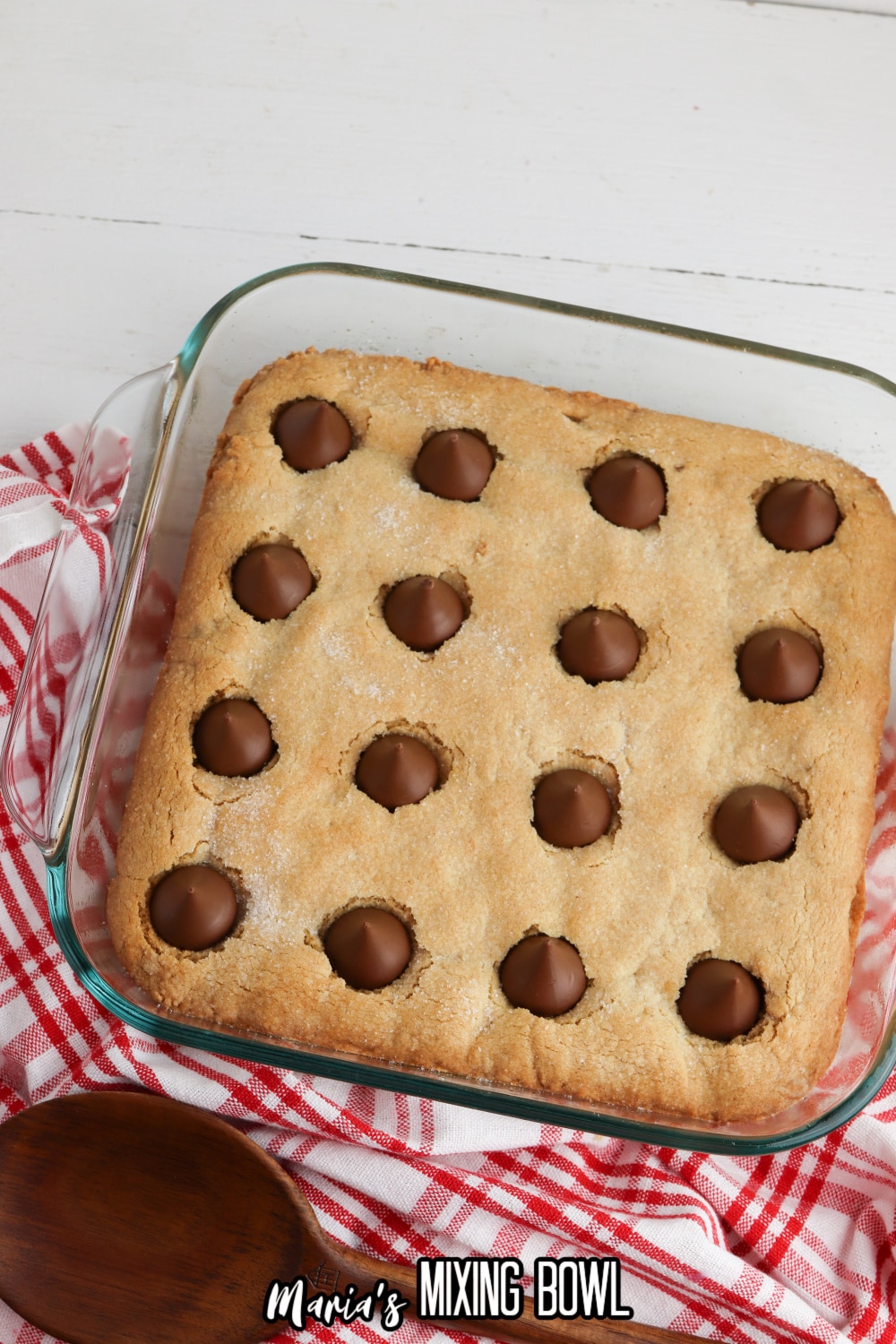 uncut peanut butter blossom bars in a glass baking dish.