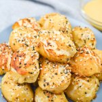 pretzel bites stacked in a pyramid on a plate.