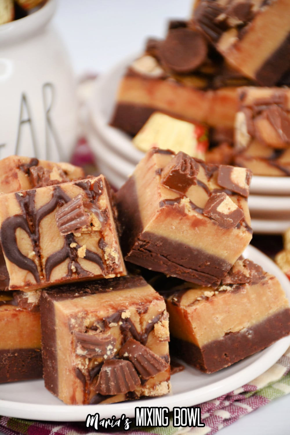 reese's peanut butter cup fudge staked on a white plate.