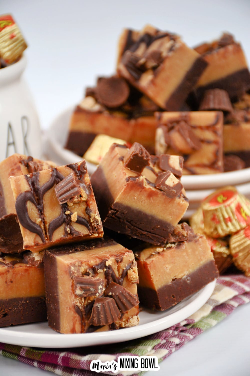 reese's peanut butter cup fudge staked on a white plate.