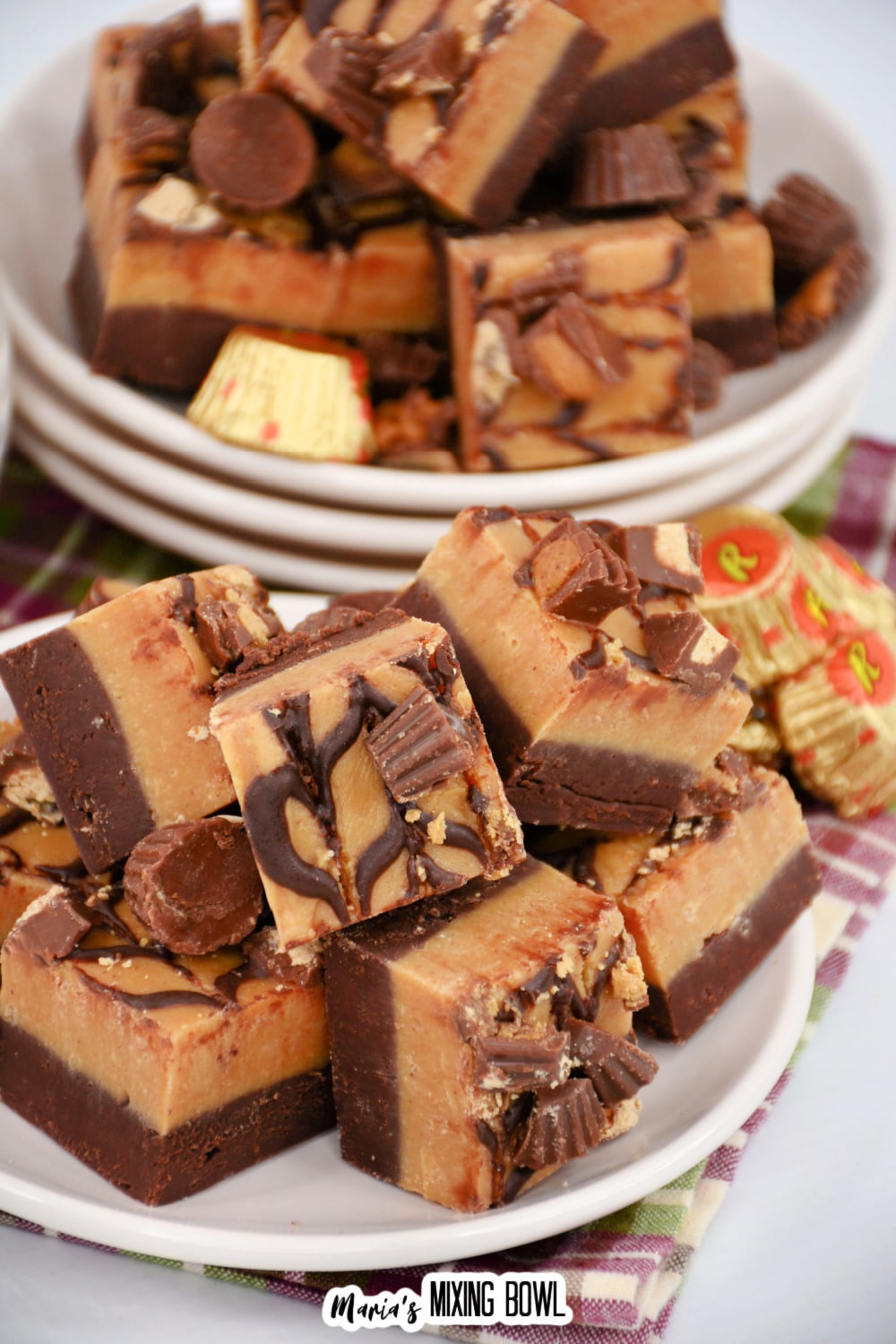 reese's peanut butter cup fudge staked on a white plate.