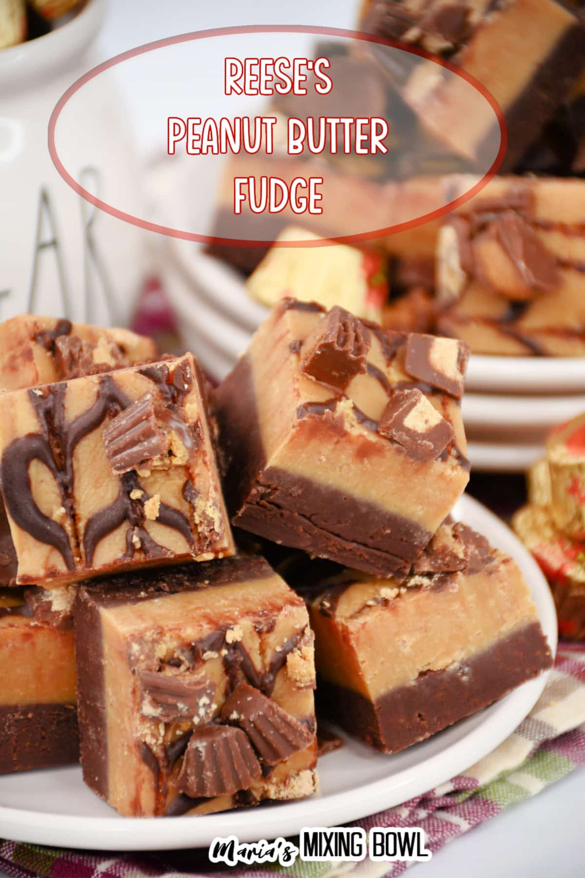 reese's peanut butter cup fudge staked on a white plate.