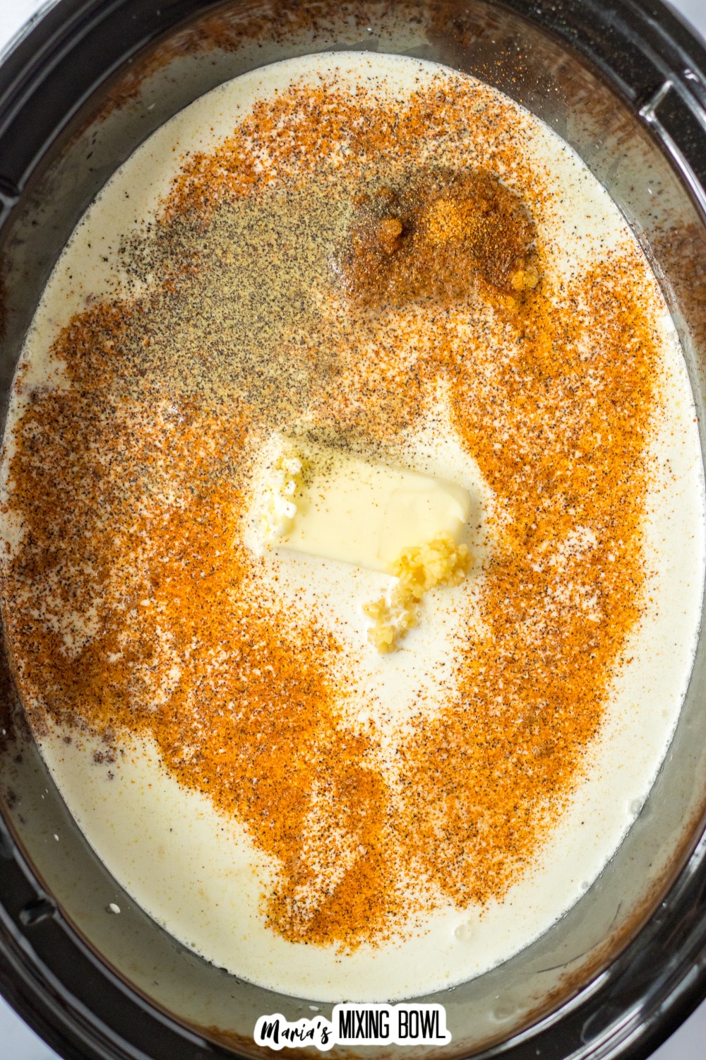 butter, heavy cream, and seasonings in the slow cooker.