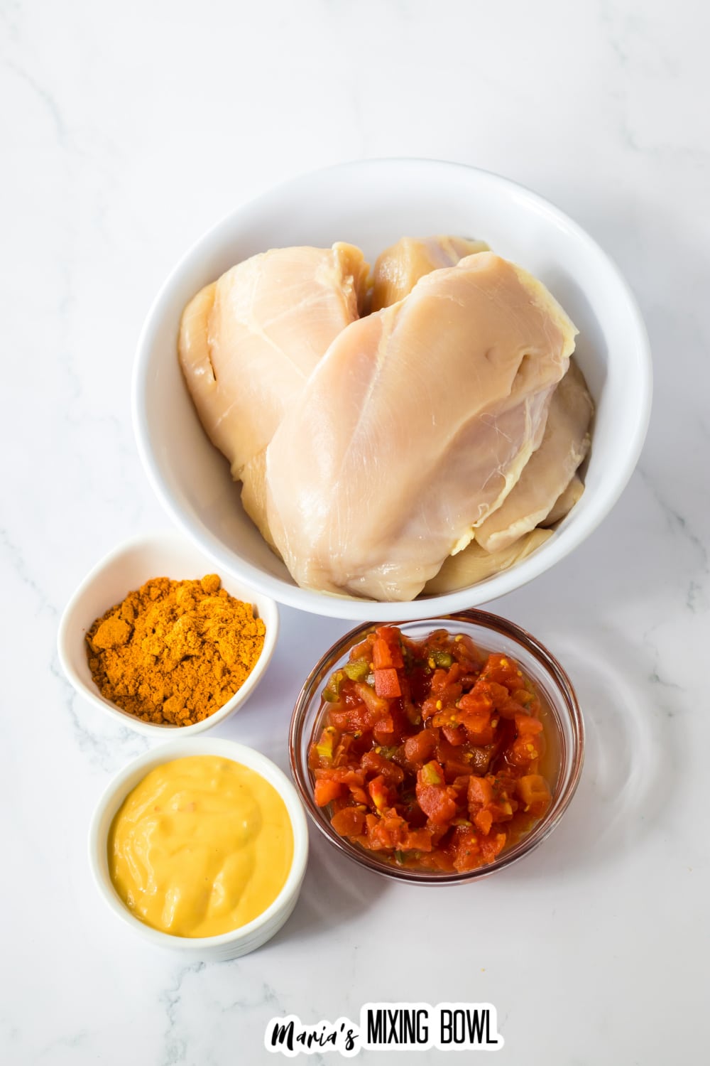 bowls of raw chicken breasts, taco seasoning, queso cheese, and salsa.