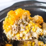 spoonful of slow cooker tater tot casserole held in the air.