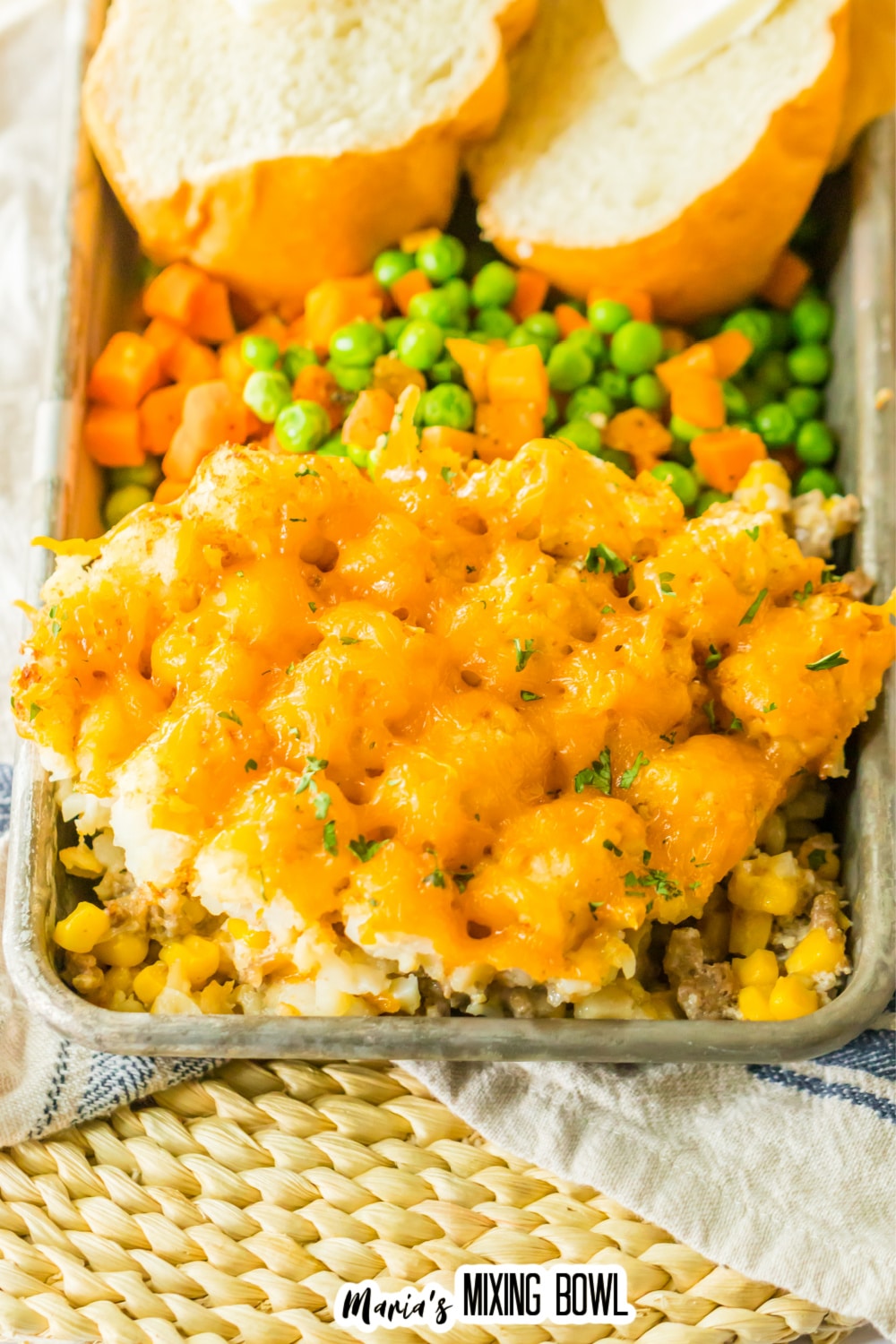 slice of slow cooker tater tot casserole on a metal serving tray.