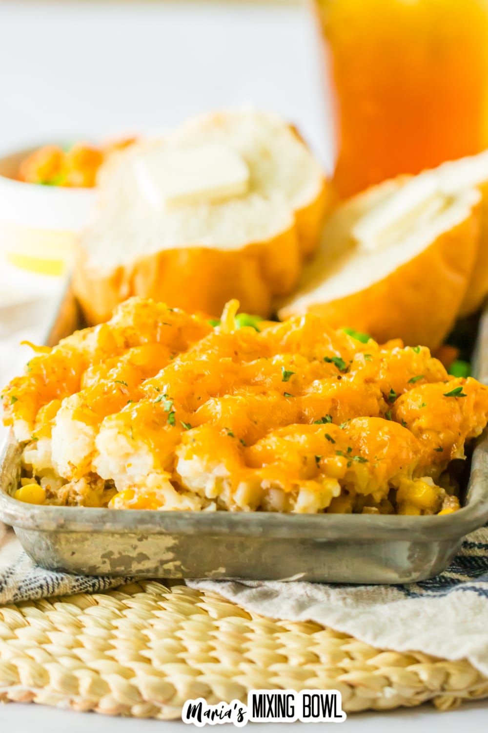 slice of slow cooker tater tot casserole on a metal serving tray.