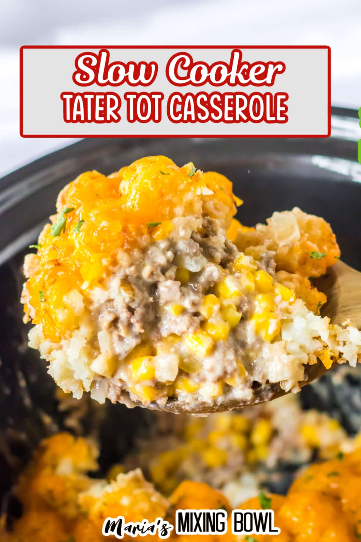 spoonful of slow cooker tater tot casserole held in the air.