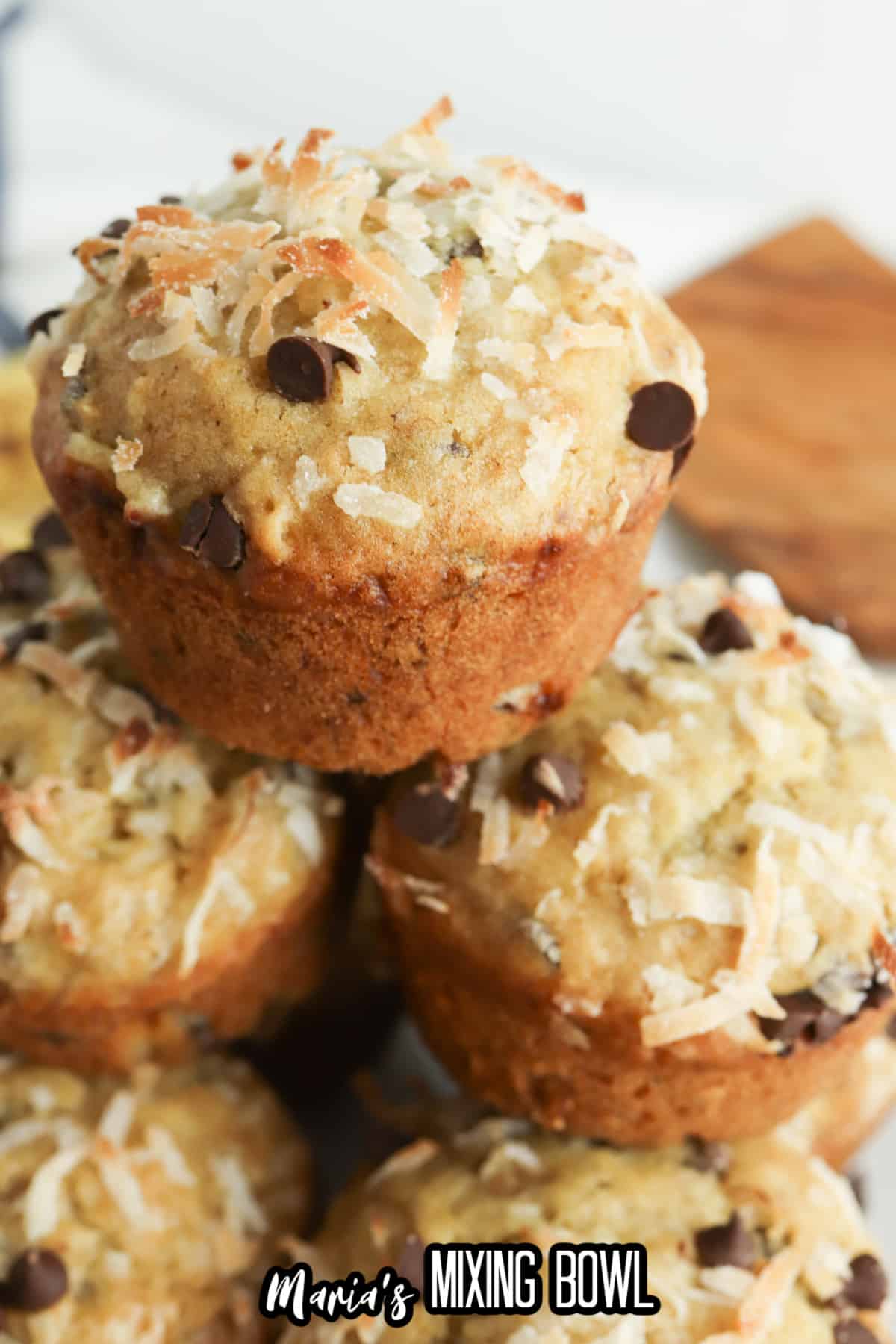 stack of banana coconut muffins on a plate.