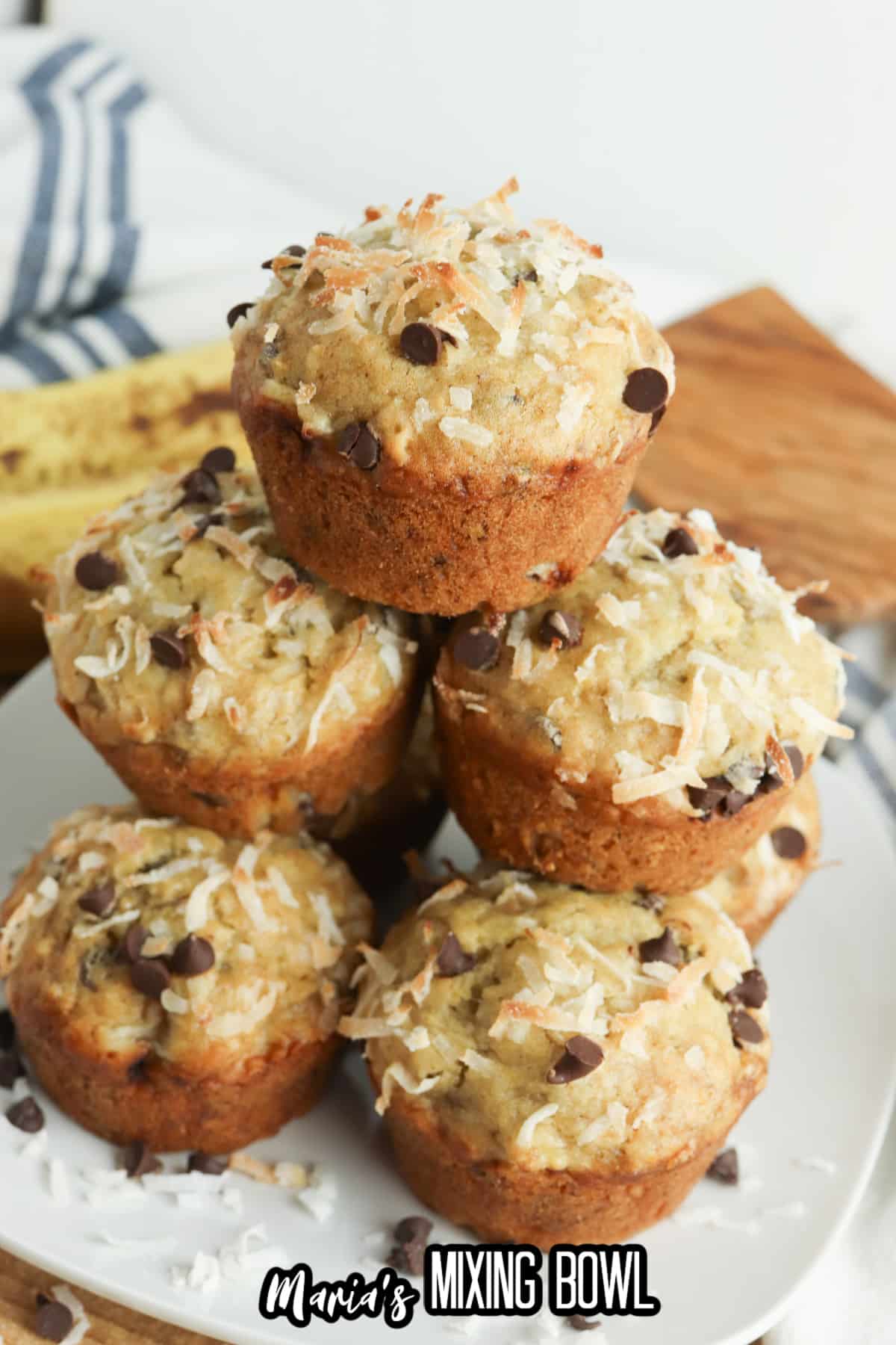 stack of banana coconut muffins on a plate.