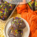 two black velvet cookies on a small stack of plates.