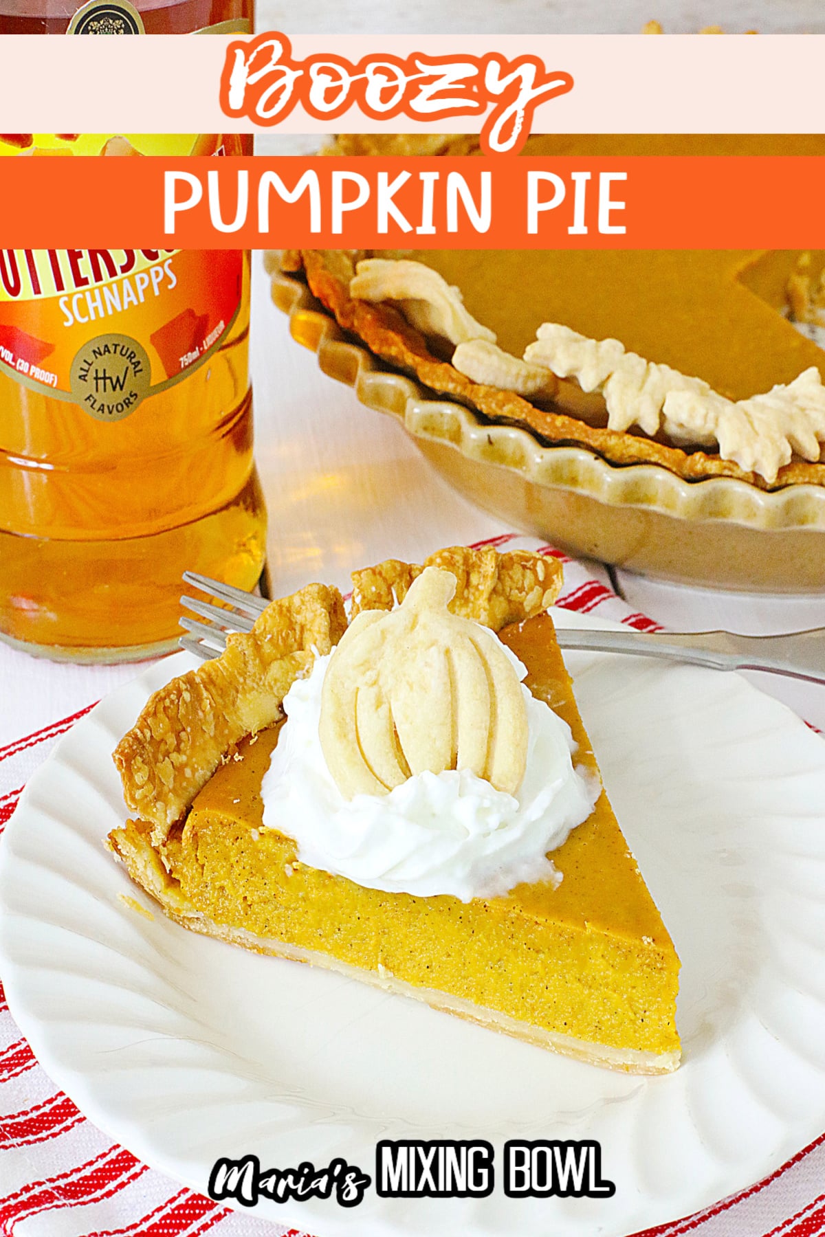 slice of boozy pumpkin pie topped with whipped cream on a plate.