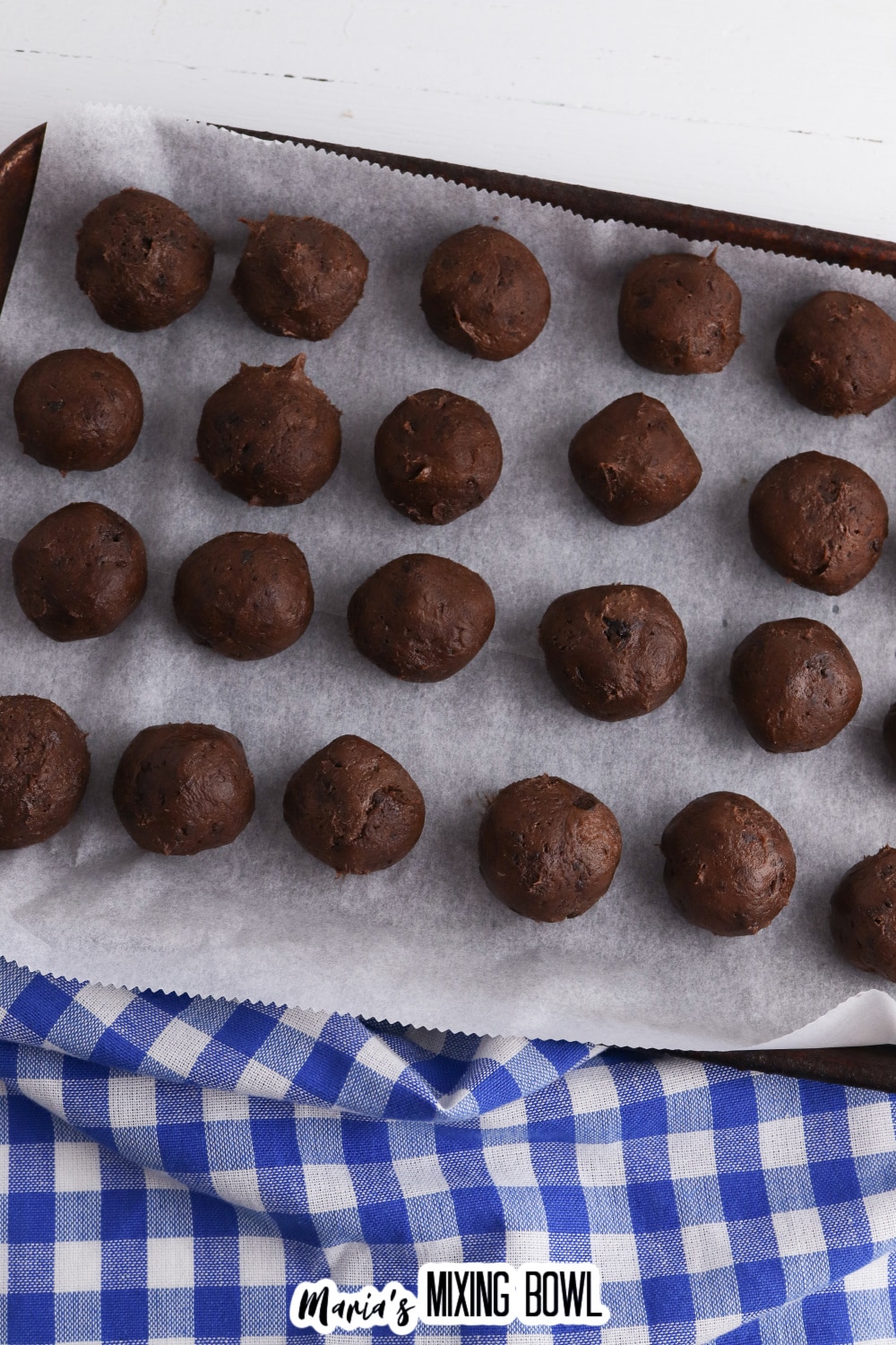 undipped brownie truffles on a parchment lined baking sheet.
