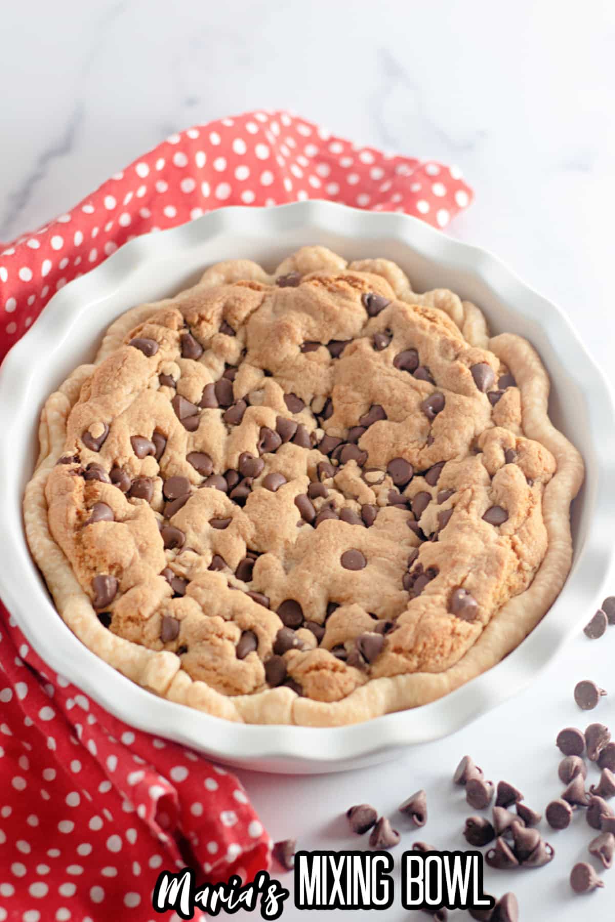 baked and uncut chocolate chip cookie pie in a pie plate.
