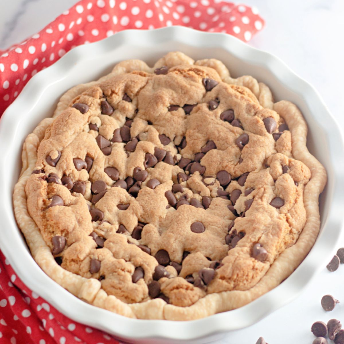 finished chocolate chip cookie pie in a plate plate.