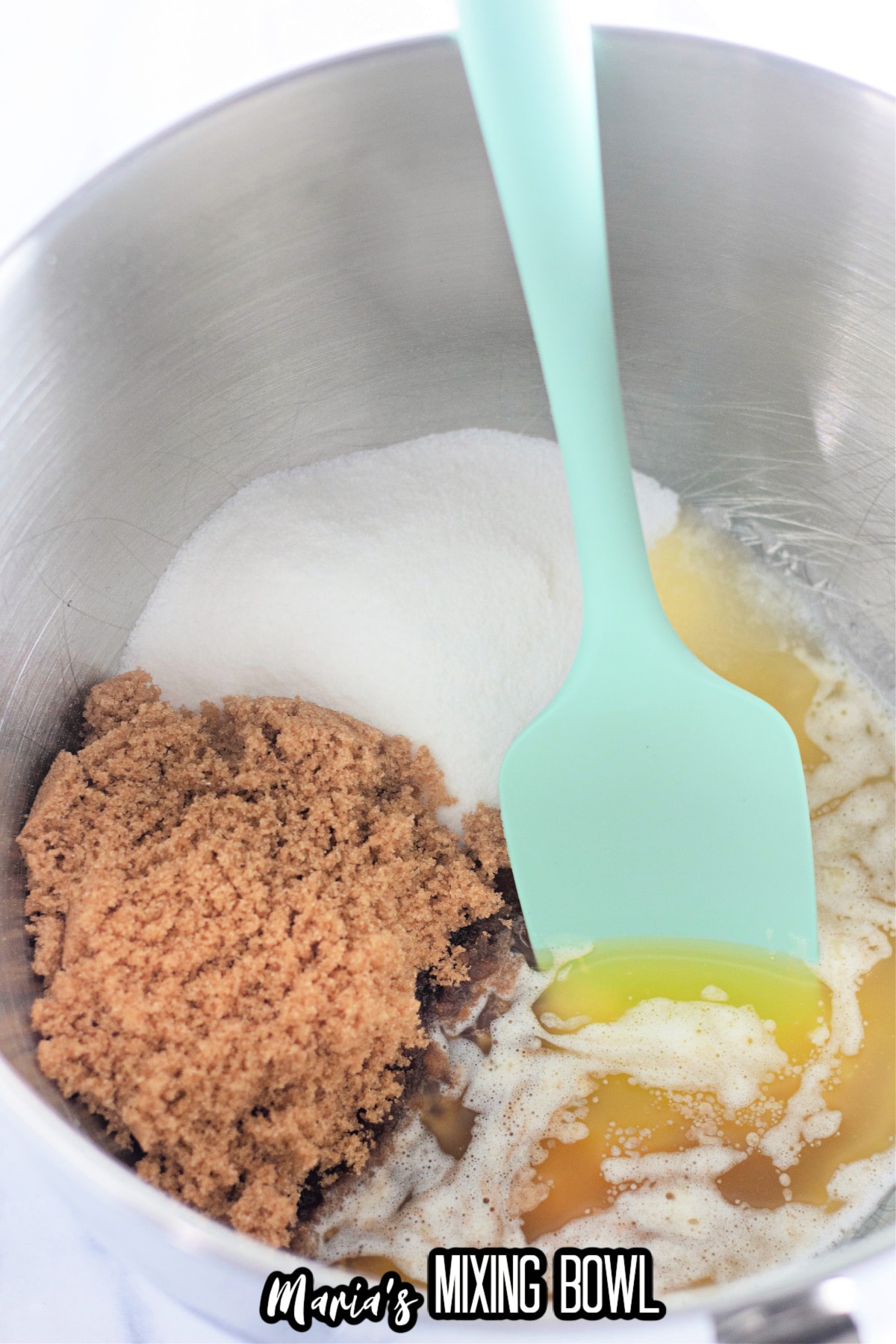 sugar, brown sugar, eggs, and melted butter in a stainless steel mixing bowl.