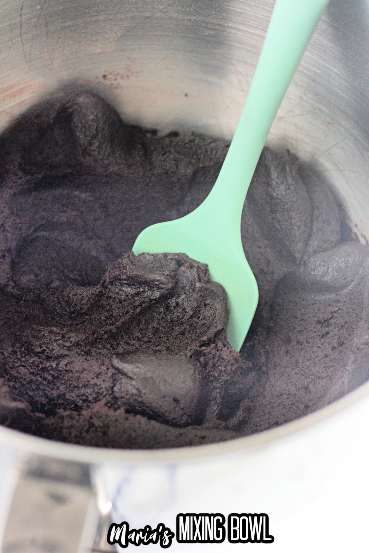 chocolate cookie dough in a stainless steel mixing bowl.