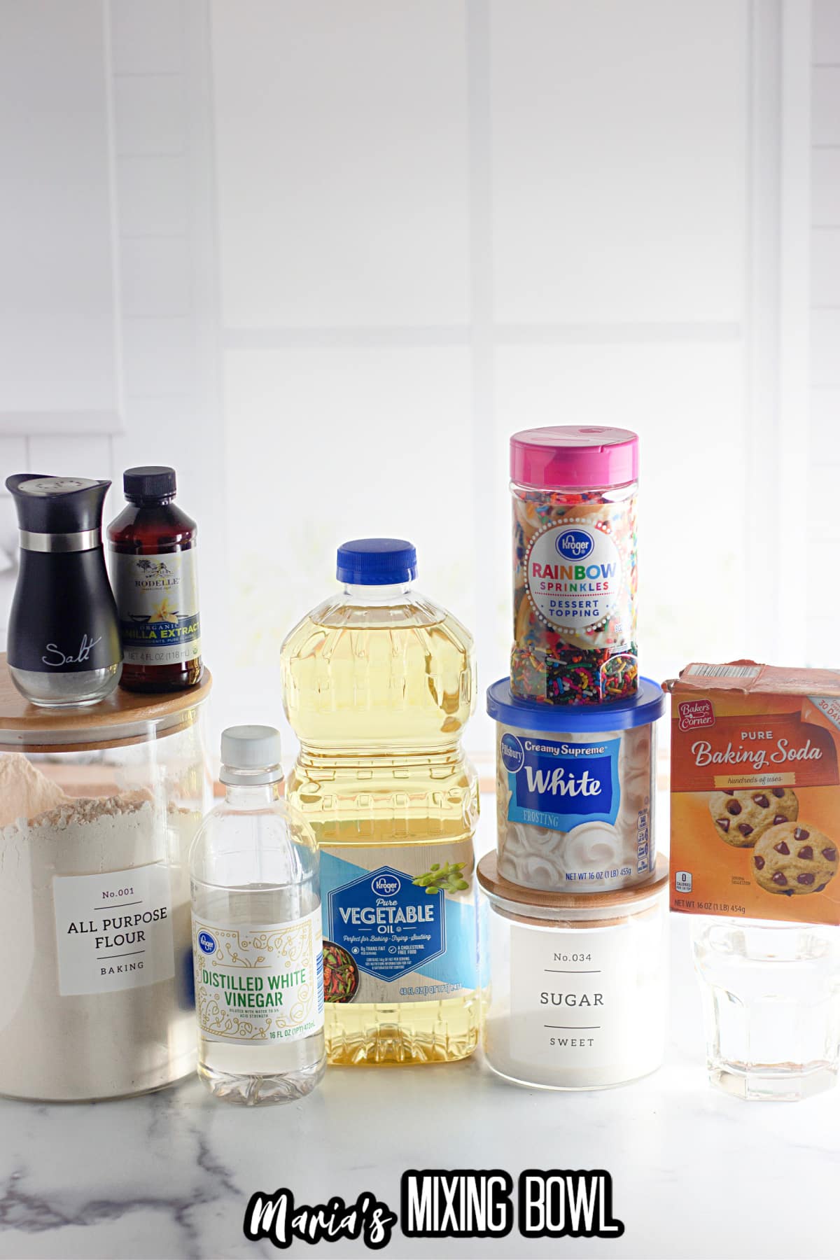 all purpose flour, salt, vanilla, vinegar, rainbow sprinkles, container frosting, sugar, baking soda and water.