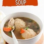 bowl of matzo ball soup with a spoon in it.