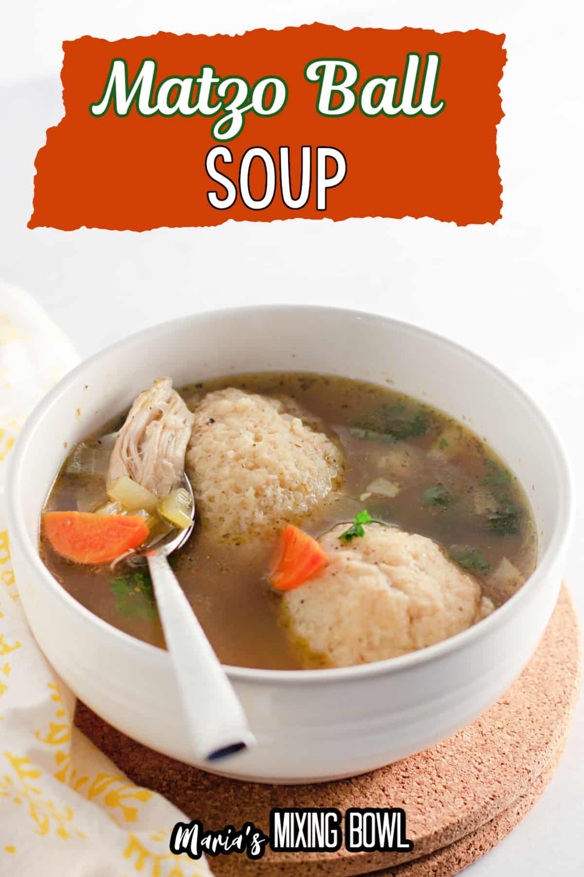 bowl of matzo ball soup with a spoon in it.